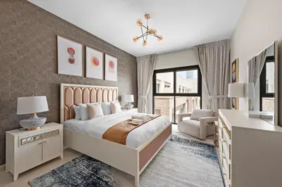 a bedroom with a bed and a desk and a chair at Brand New 2 Br Apartment In Family Community in Dubai