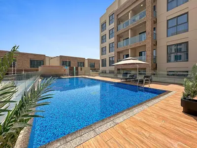 a swimming pool in the middle of a building at Brand New 2 Br Apartment In Family Community in Dubai