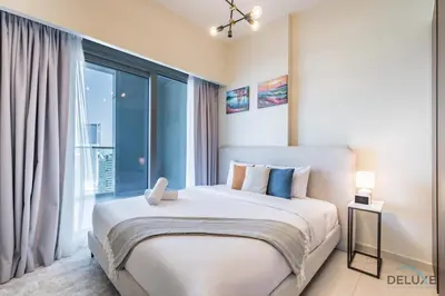 a bedroom with a large bed with a large window at Special Deal 2BR with Canal Views & Relaxing Balcony by Deluxe Holiday Homes in Dubai