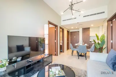 a living room with a couch and a table at Special Deal 2BR with Canal Views & Relaxing Balcony by Deluxe Holiday Homes in Dubai