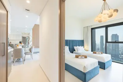 two beds in a hotel room with a view at Luxury Home on the 50th Floor with Full Burj View in Dubai