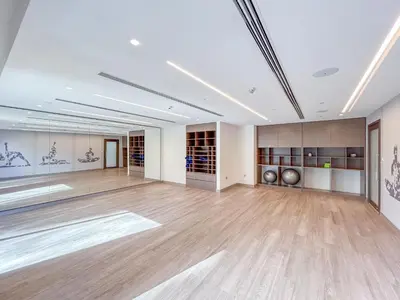 an empty room with a large room with wood floors and ceilings at Luxury Home on the 50th Floor with Full Burj View in Dubai