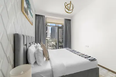 a bedroom with a white bed and a window at ALiving Classy 1BR I Near Burj Khalifa & Dubai Mall I Missoni Tower- 211 in Dubai