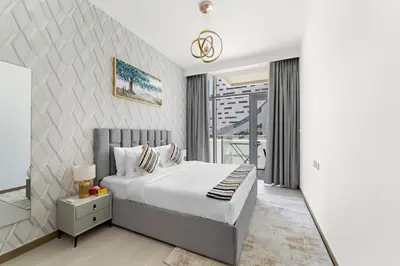 a bedroom with a bed and a balcony at ALiving Classy 1BR I Near Burj Khalifa & Dubai Mall I Missoni Tower- 211 in Dubai