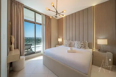 a bedroom with a large white bed and a window at Burj Khalifa View Big terrace 1BR in Prime Views in Dubai