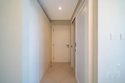 a hallway with white walls and a white door at Burj Khalifa View Big terrace 1BR in Prime Views in Dubai
