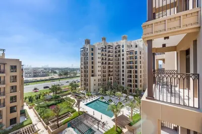 a view from the balcony of a apartment building with a pool at A Living One 1BR Apartment At Asayel 3, Madinat Jumeirah in Dubai