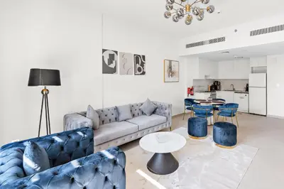 a living room with a couch and a table at A Living One 1BR Apartment At Asayel 3, Madinat Jumeirah in Dubai