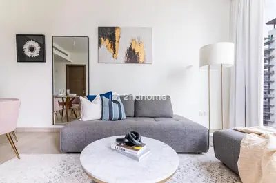 a living room with a couch and a table at Fully Equipped Residence at One Park Avenue in Dubai