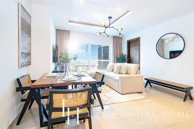 a living room with a dining table and a couch at LUX The Bonnington JLT Suite 2 in Dubai