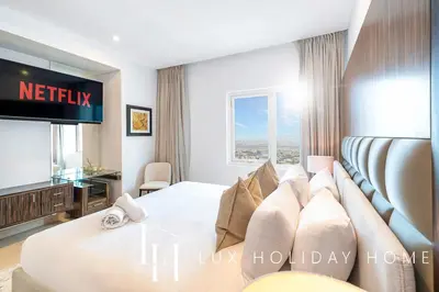 a hotel room with a bed and a television at LUX The Bonnington JLT Suite 2 in Dubai