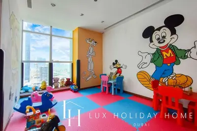a room with a mickey mouse mural on the wall at LUX The Bonnington JLT Suite 2 in Dubai