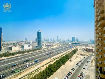 a view of a highway in a city with buildings at Royalton - Tranquil 15th-Floor Apartment with City Views in Dubai