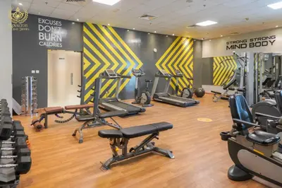a gym with several treadmills and exercise bikes at Royalton - Tranquil 15th-Floor Apartment with City Views in Dubai