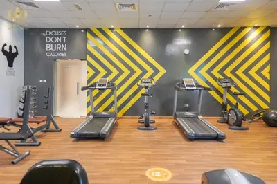 a gym with several treadmills and cardio machines at Royalton - Tranquil 15th-Floor Apartment with City Views in Dubai