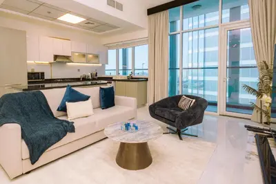 a living room with a couch and a table at WelHome - Opulent Retreat With Panoramic Cityscape Views in Dubai