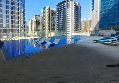 a swimming pool in a city with tall buildings at WelHome - Opulent Retreat With Panoramic Cityscape Views in Dubai