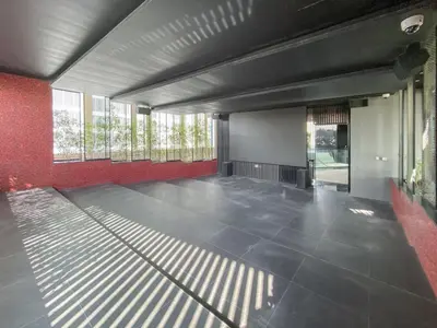 a large empty room with red walls and windows at WelHome - Opulent Retreat With Panoramic Cityscape Views in Dubai