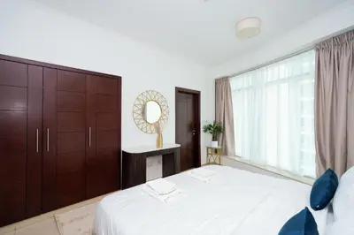 a bedroom with a large bed and a large window at Lovely 1BHK in Burj views tower near Dubai mall in Dubai