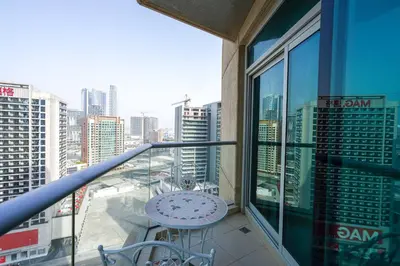 a balcony with a table and a view of a city at Lovely 1BHK in Burj views tower near Dubai mall in Dubai