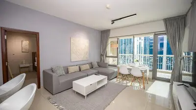 a living room with a couch and a table at Burj and fountain view 3BHK Near Dubai Mall in Dubai