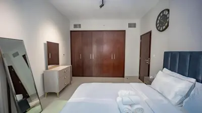 a bedroom with a large bed with towels on it at Burj and fountain view 3BHK Near Dubai Mall in Dubai