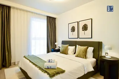 a bedroom with a bed with two towels on it at Luxury Escapes - ME DO RE Tower JLT in Dubai
