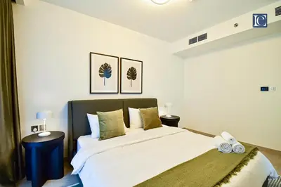 a bedroom with a large bed with white sheets at Luxury Escapes - ME DO RE Tower JLT in Dubai
