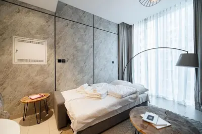 a hotel room with a bed and a table at SettlerHomes - Serene Downtown Stay on the High-Floor in Dubai