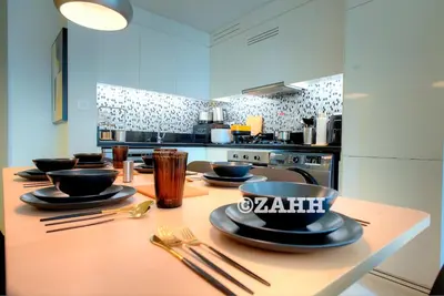 a kitchen with a table with plates and utensils at Business Bay Retreat in Dubai