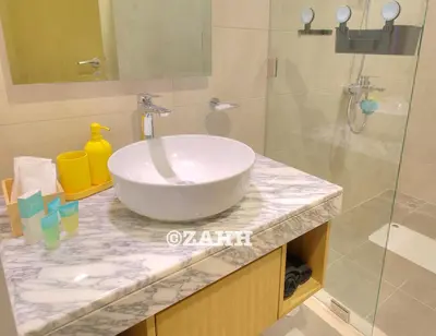 a bathroom with a white sink and a shower at Business Bay Retreat in Dubai
