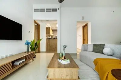 a living room with a couch and a coffee table at ShoresInn - Elegant 1BR in Dubai Marina in Dubai