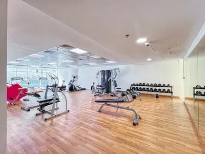 a gym with treadmills and machines in a room at ShoresInn - Elegant 1BR in Dubai Marina in Dubai