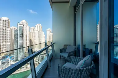 a balcony with chairs and a view of the city at Luxury Apartment in Dubai Marina w Stunning View in Dubai