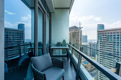 a balcony with a chair and a view of a city at Luxury Apartment in Dubai Marina w Stunning View in Dubai