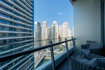a balcony with chairs and a view of the city at Luxury Apartment in Dubai Marina w Stunning View in Dubai