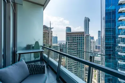 a balcony with a couch and a view of the city at Luxury Apartment in Dubai Marina w Stunning View in Dubai