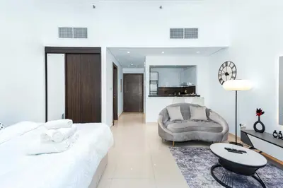 a bedroom with a large bed and a chair at Luxury Apartment in Dubai Marina w Stunning View in Dubai