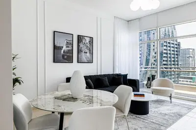 a living room with a couch and a table and chairs at 2BR City View Bay Square B13 in Dubai
