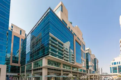 a tall building with blue windows in a city at 2BR City View Bay Square B13 in Dubai