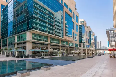 a large building with a pool in front of it at 2BR City View Bay Square B13 in Dubai
