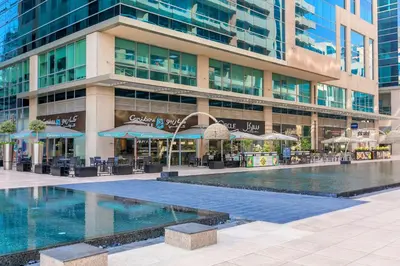 a building with a swimming pool in front of a building at 2BR City View Bay Square B13 in Dubai