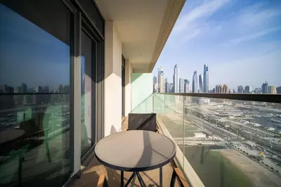 a balcony with a table and a view of a city at SettlerHomes - Emaar Beachfront Haven With The Sea View in Dubai