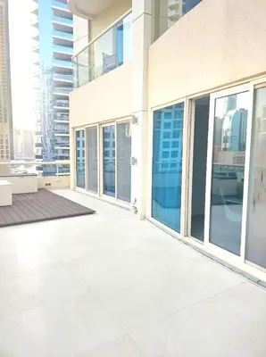 a large building with glass doors and a balcony at Upgraded 2 bedroom at Dubai Marina in Dubai