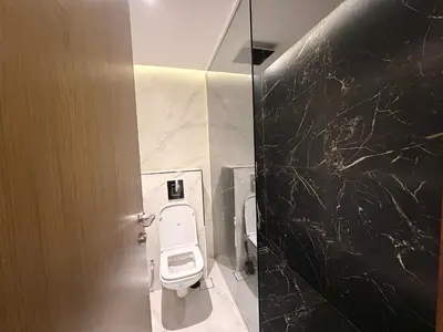 a bathroom with a white toilet in a stall at Upgraded 2 bedroom at Dubai Marina in Dubai