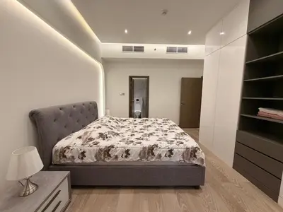 a bedroom with a bed and a dresser with a lamp at Upgraded 2 bedroom at Dubai Marina in Dubai