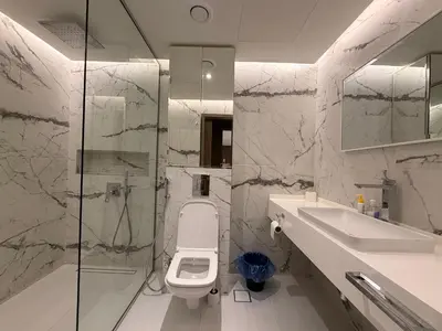 a bathroom with a toilet and a sink and a shower at Upgraded 2 bedroom at Dubai Marina in Dubai