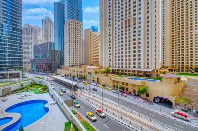 a city street with traffic in a city with tall buildings at ShoresInn - Stylish Space in Dubai Marina in Dubai