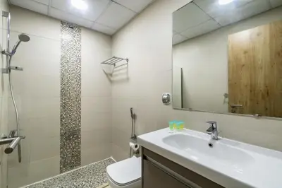 a bathroom with a sink and a toilet and a mirror at ShoresInn - Stylish Space in Dubai Marina in Dubai