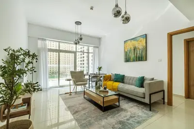 a living room with a couch and a table at ShoresInn - Stylish Space in Dubai Marina in Dubai